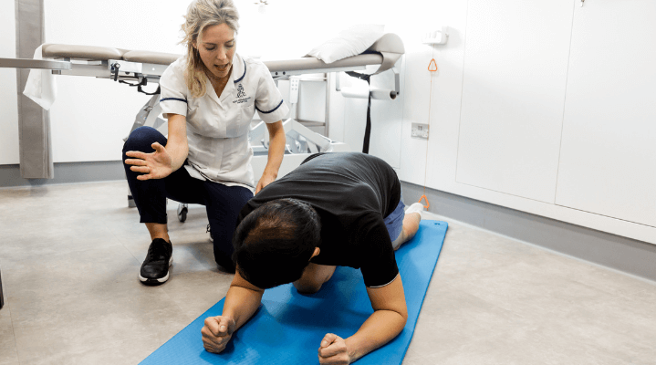 Man working with Pelvic Floor Physiotherapist on stretching exercises